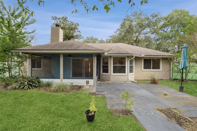 a front view of house with yard and trees