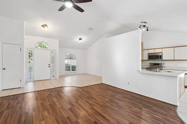 wooden floor in an empty room with a window