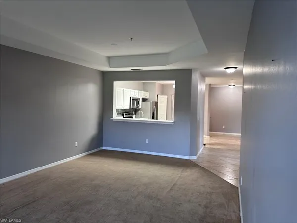 an empty room with windows and entrance