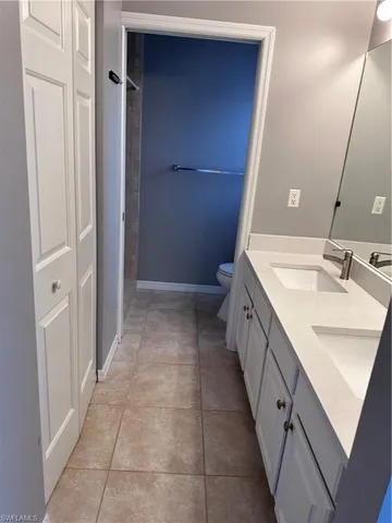 a bathroom with a double vanity sink and mirror