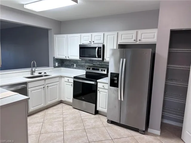 a kitchen with a sink stove and refrigerator