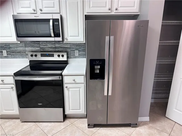 a kitchen with stainless steel appliances a stove microwave and refrigerator