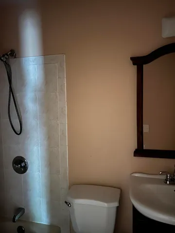 a bathroom with a toilet sink and shower