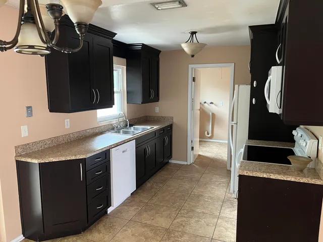 a kitchen with a sink stove and refrigerator