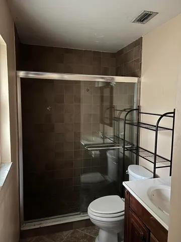 a bathroom with a toilet a sink and a shower