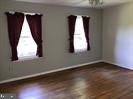 41316 Red Hill Road Leesburg, VA 20175 - Photo 22 of 36 an empty room with wooden floor and windows