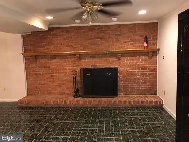wooden floor fireplace and natural light in room