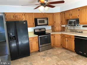 41316 Red Hill Road Leesburg, VA 20175 - Photo 36 of 36 a kitchen with stainless steel appliances granite countertop a refrigerator a stove top oven a sink and dishwasher