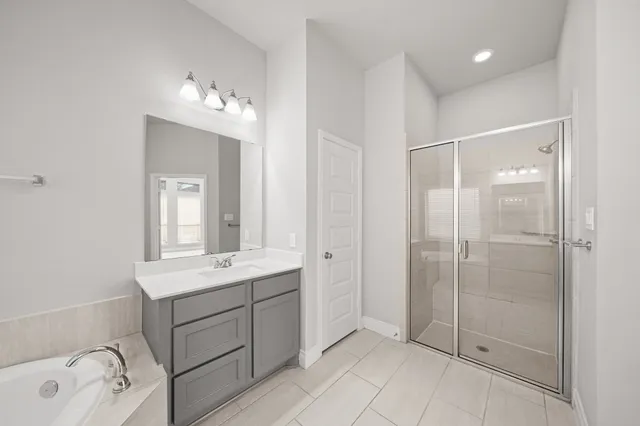 a bathroom with a shower sink and mirror