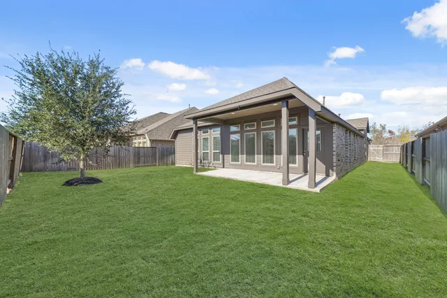 a view of a house with a backyard