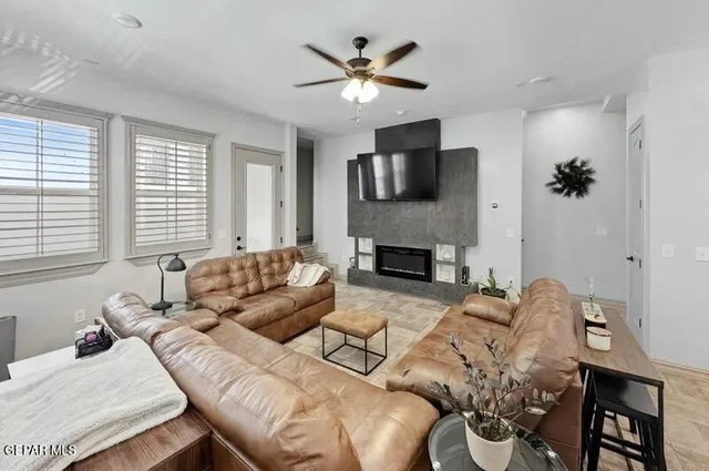 a living room with furniture a flat screen tv and a fireplace