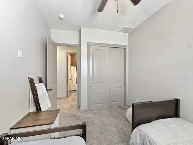 a bedroom with a bed and a chair