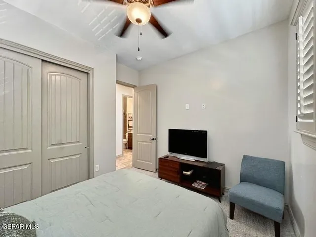 a bedroom with a bed and a television