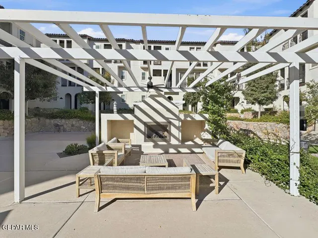 a view of a patio with a table and chairs
