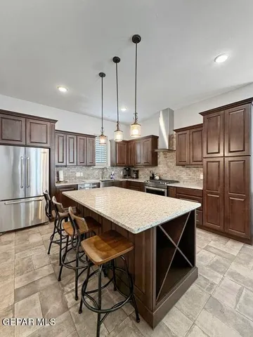 a kitchen with kitchen island a wooden floor and white appliances