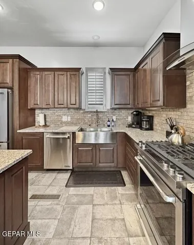 a kitchen with a stove a sink and a refrigerator