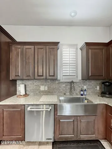 a kitchen with stainless steel appliances granite countertop a sink stove and cabinets