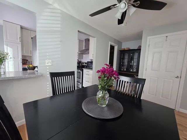 a view of a livingroom with wooden floor and a flat screen tv