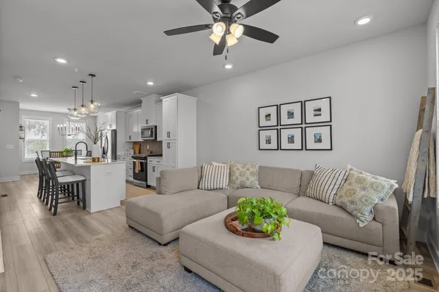 a living room with furniture and kitchen view