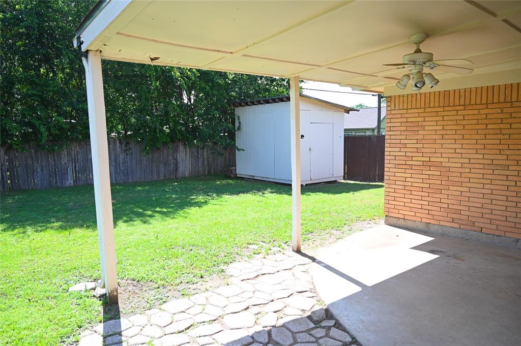 1352 Simpson Drive Hurst, TX 76053 - Photo 31 of 40 Covered patio with a ceiling fan and brick exterior