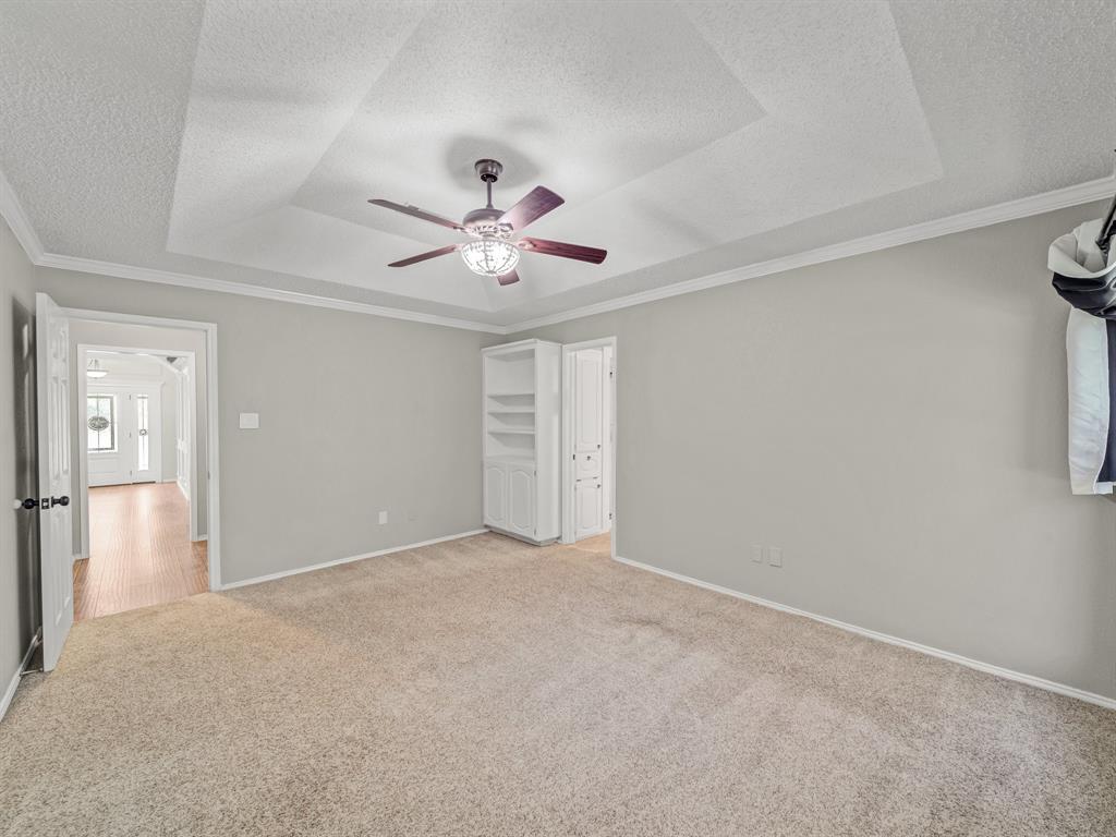 121 Northeast Brushy Mound Road Burleson, TX 76028 - Photo 26 of 35 a view of an empty room with a chandelier fan