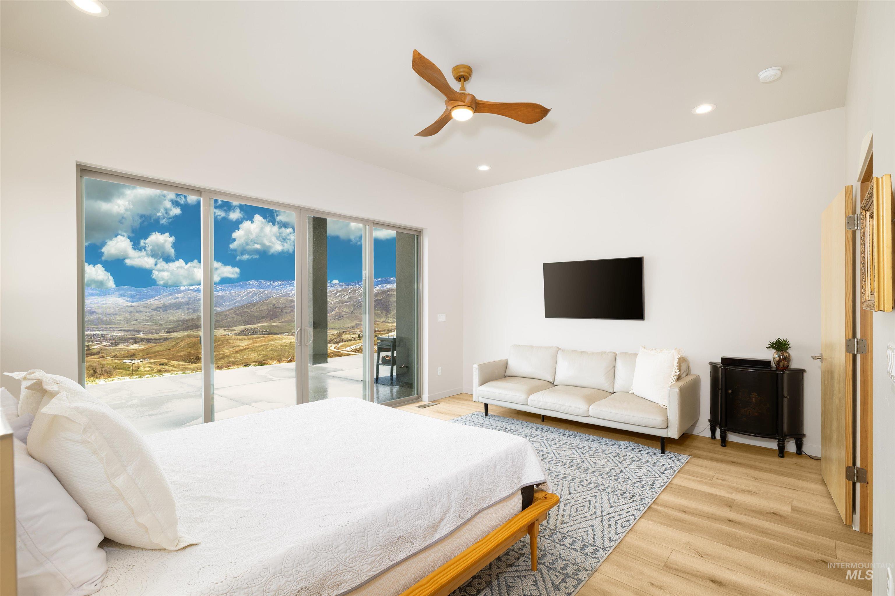 170 Summit Ridge Road Horseshoe Bend, ID 83629 - Photo 16 of 50 Bedroom featuring light wood-style flooring, access to exterior, a ceiling fan, and recessed lighting