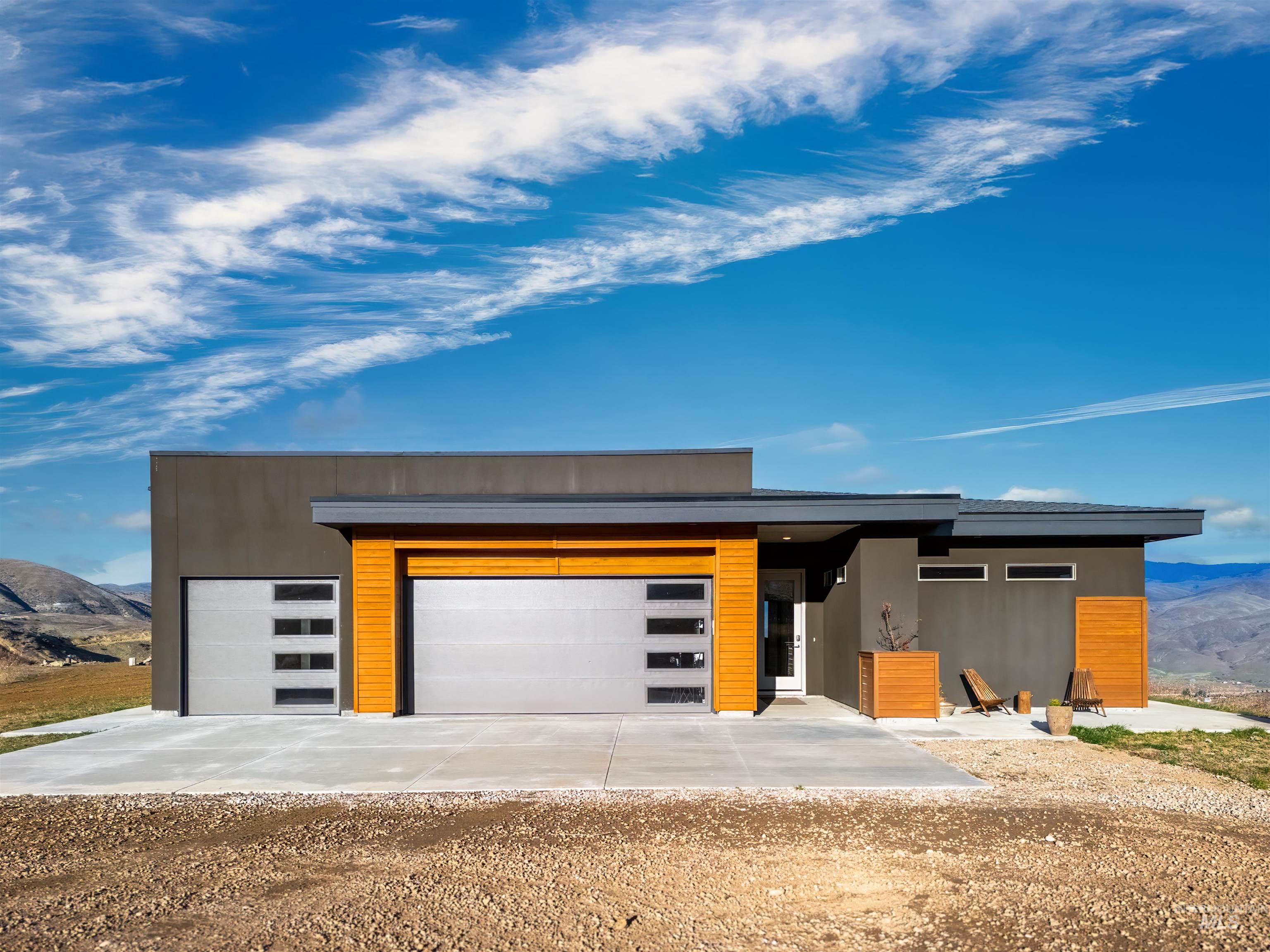 170 Summit Ridge Road Horseshoe Bend, ID 83629 - Photo 3 of 50 Contemporary home featuring a mountain view, driveway, and a garage