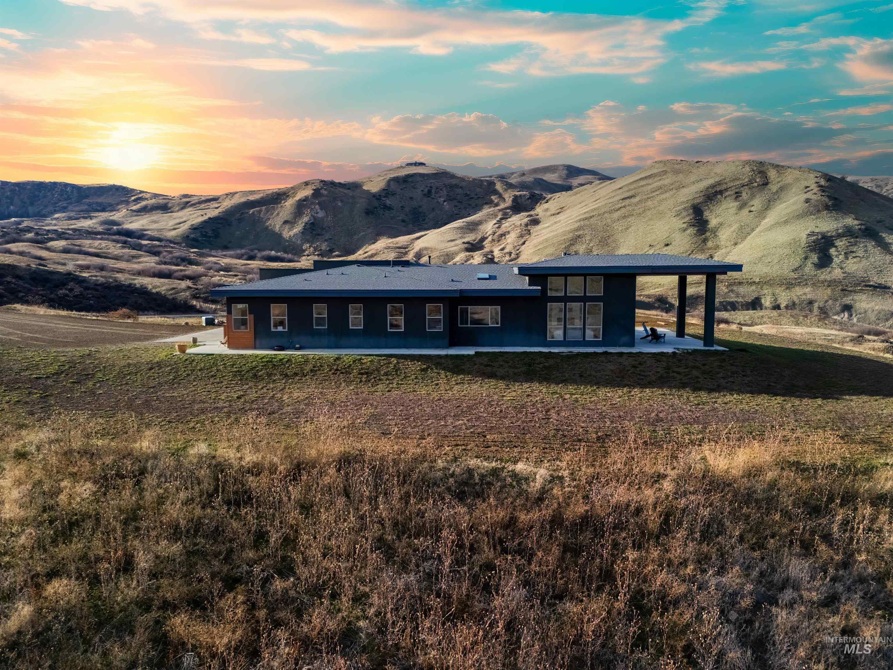170 Summit Ridge Road Horseshoe Bend, ID 83629 - Photo 37 of 50 View of front of house with a patio, a mountain view, a lawn, and french doors