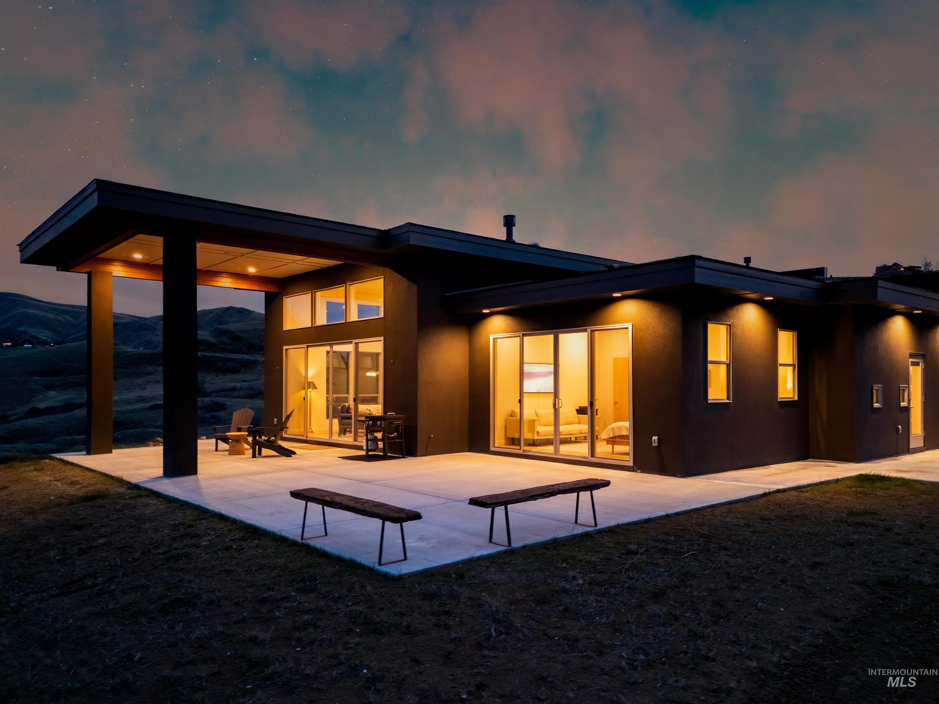 170 Summit Ridge Road Horseshoe Bend, ID 83629 - Photo 41 of 50 Back of property with stucco siding and a patio area