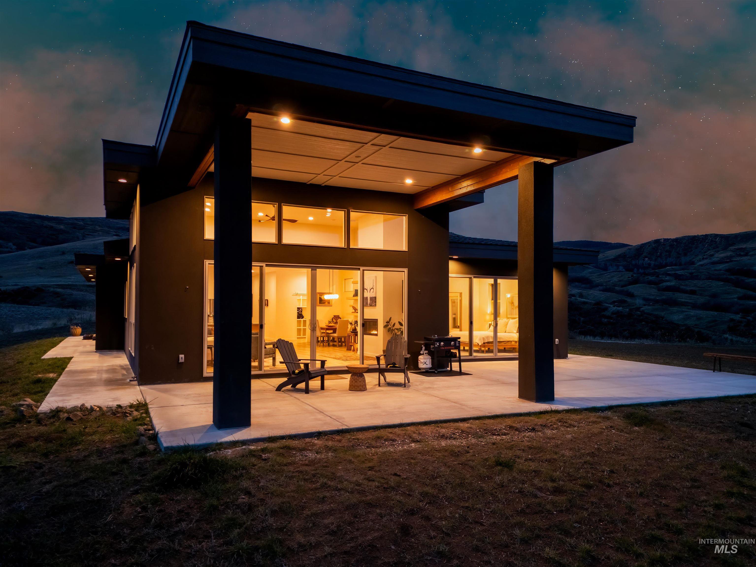 170 Summit Ridge Road Horseshoe Bend, ID 83629 - Photo 42 of 50 Back of house with a patio, stucco siding, a mountain view, and a yard