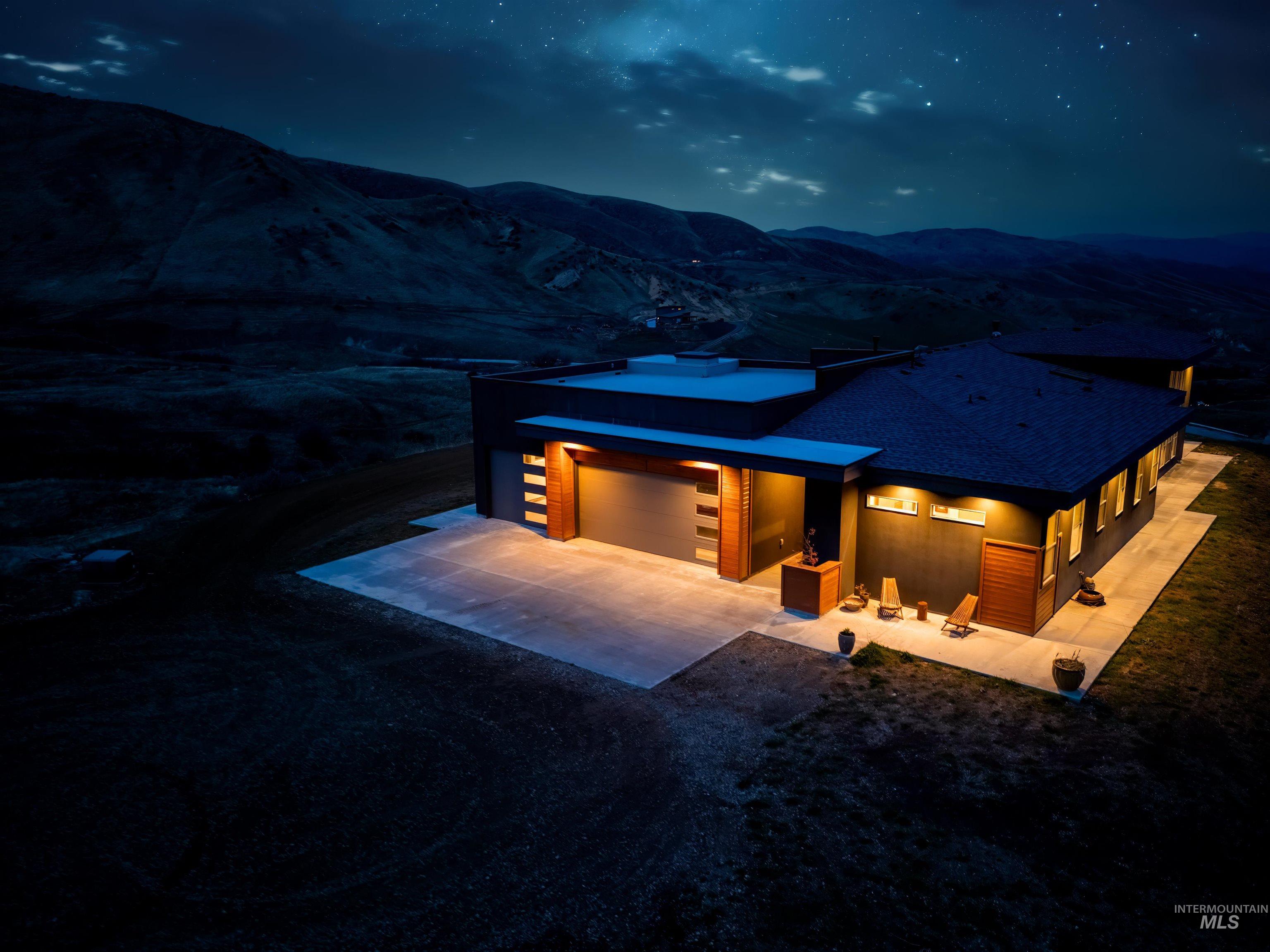 170 Summit Ridge Road Horseshoe Bend, ID 83629 - Photo 44 of 50 View of front of property featuring driveway, a patio area, and an attached garage