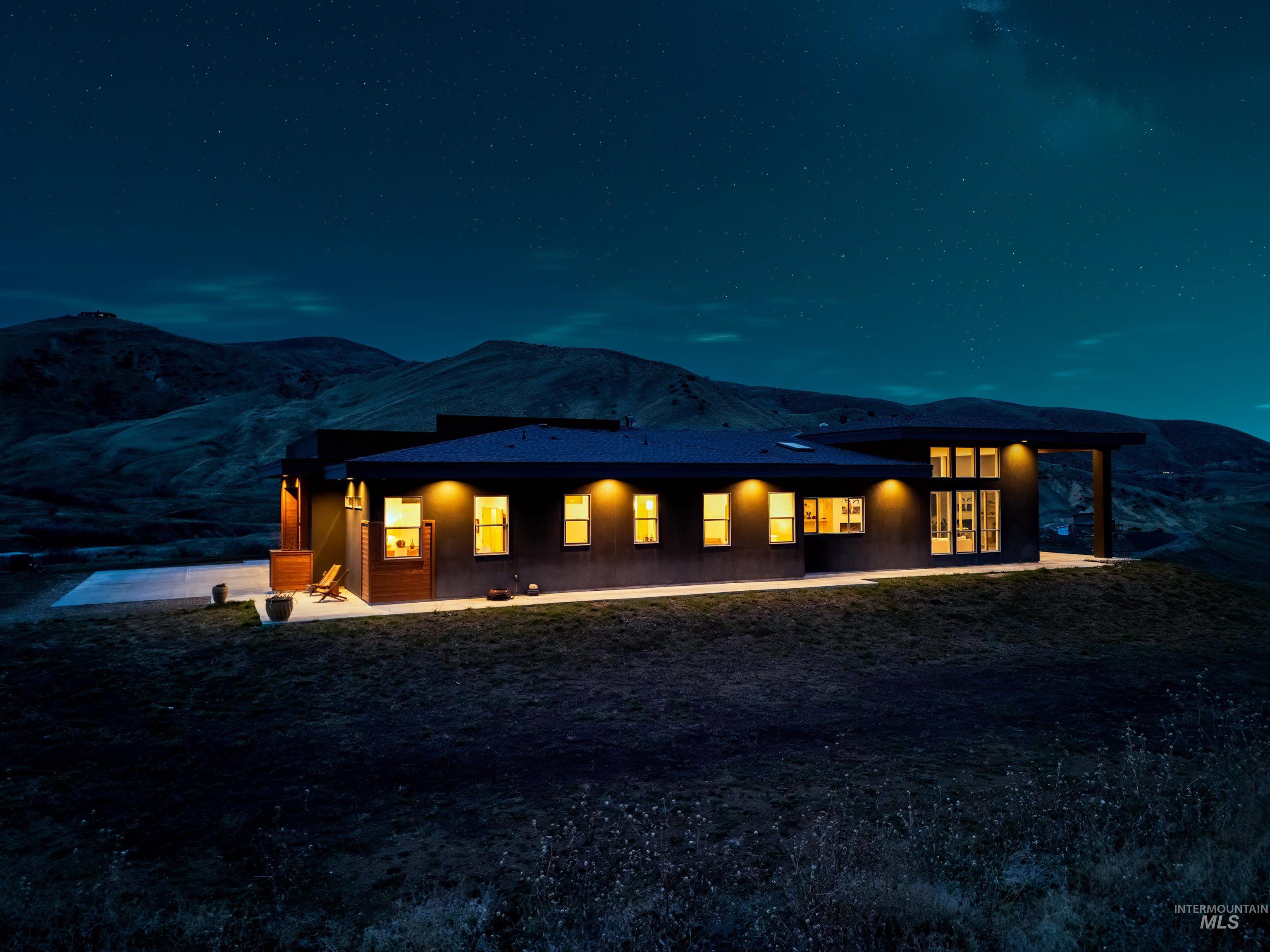 170 Summit Ridge Road Horseshoe Bend, ID 83629 - Photo 45 of 50 Back of house at twilight featuring a patio