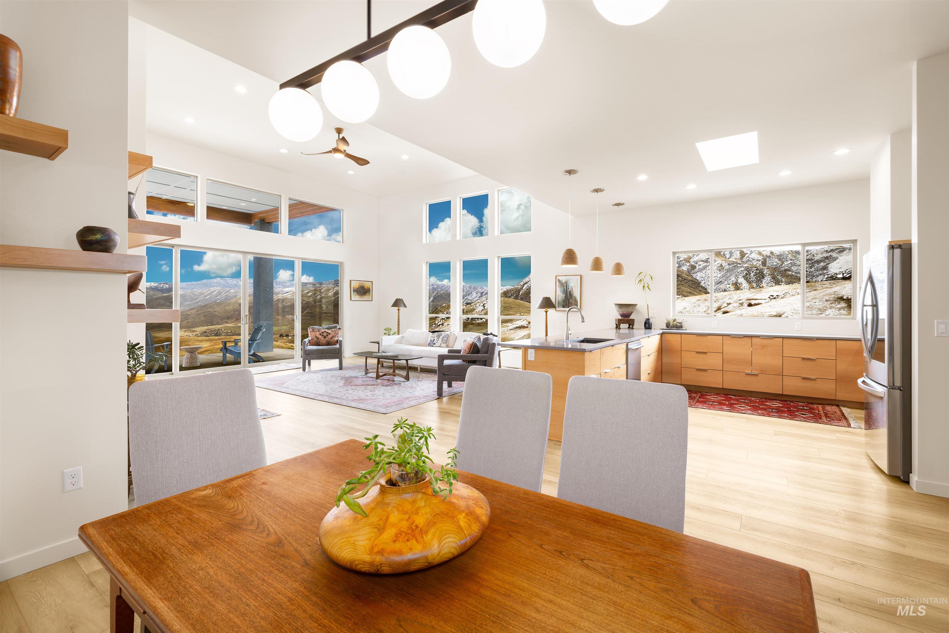 170 Summit Ridge Road Horseshoe Bend, ID 83629 - Photo 7 of 50 Dining area featuring light wood-style flooring, a skylight, and a towering ceiling
