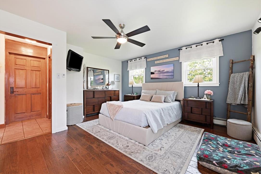 7722 Sechler Road New Tripoli, PA 18066 - Photo 25 of 58 Rich hardwood flooring complements the detailed wood doors and classic windows of this bedroom.