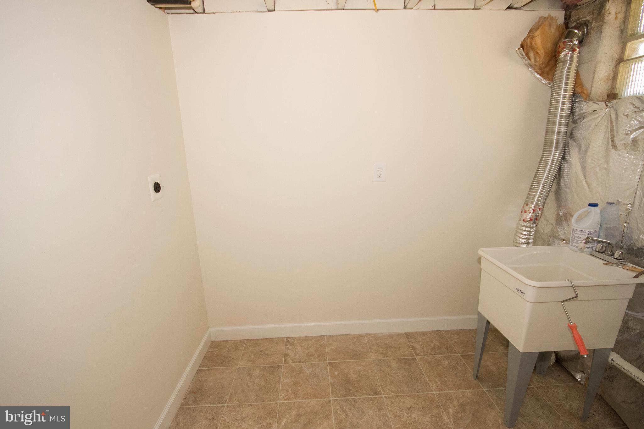 1381 Deanwood Road Baltimore, MD 21234 - Photo 14 of 27 a bathroom with a sink a toilet and a mirror