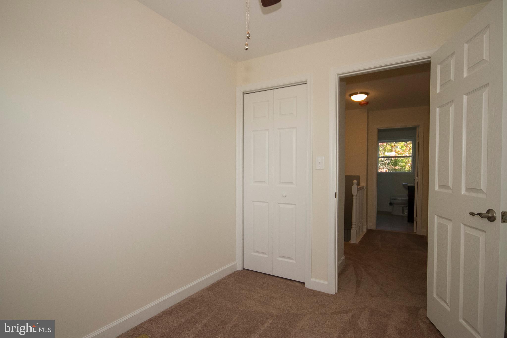 1381 Deanwood Road Baltimore, MD 21234 - Photo 17 of 27 an empty room with closet and a bathroom