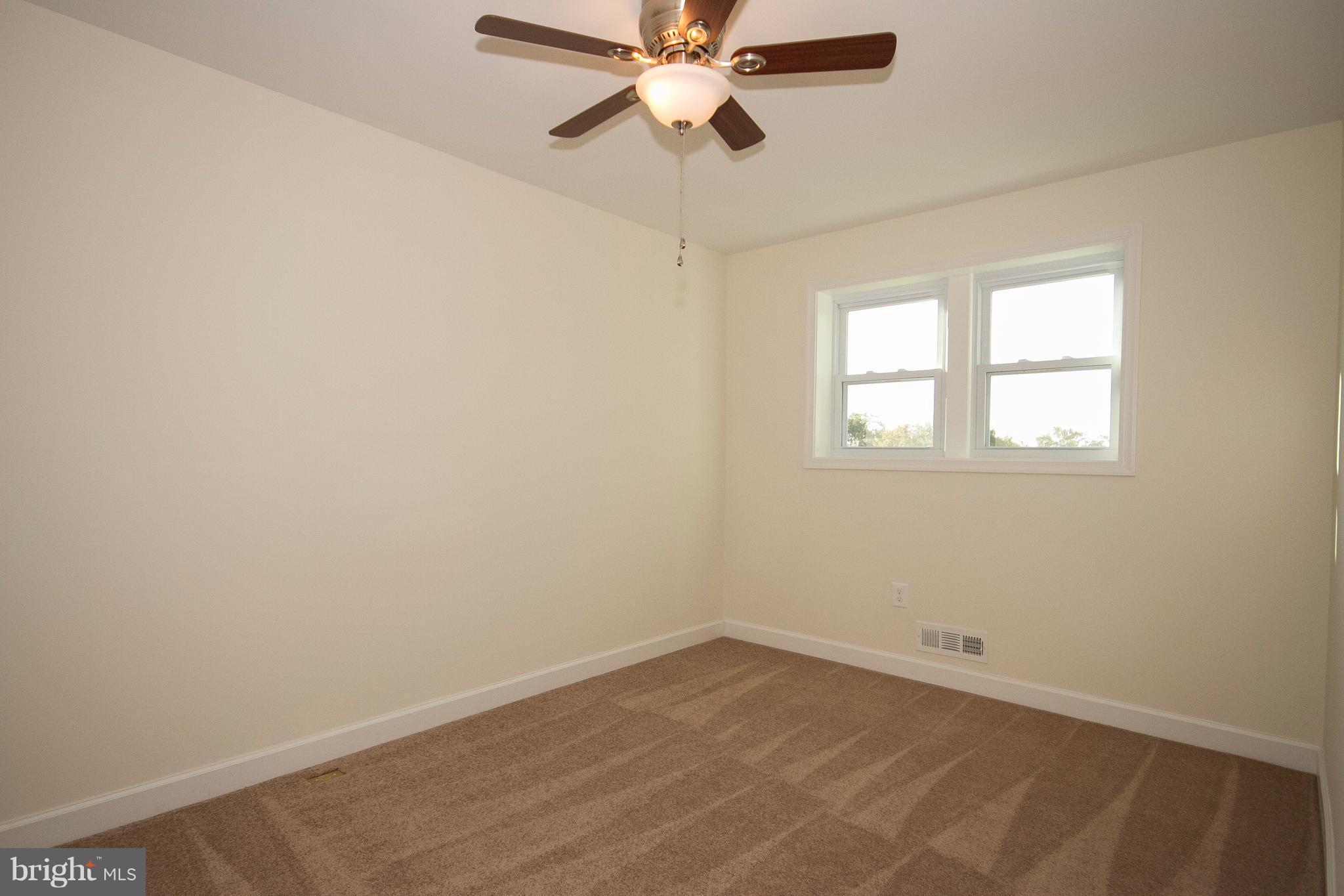 1381 Deanwood Road Baltimore, MD 21234 - Photo 18 of 27 an empty room with a window and a fan