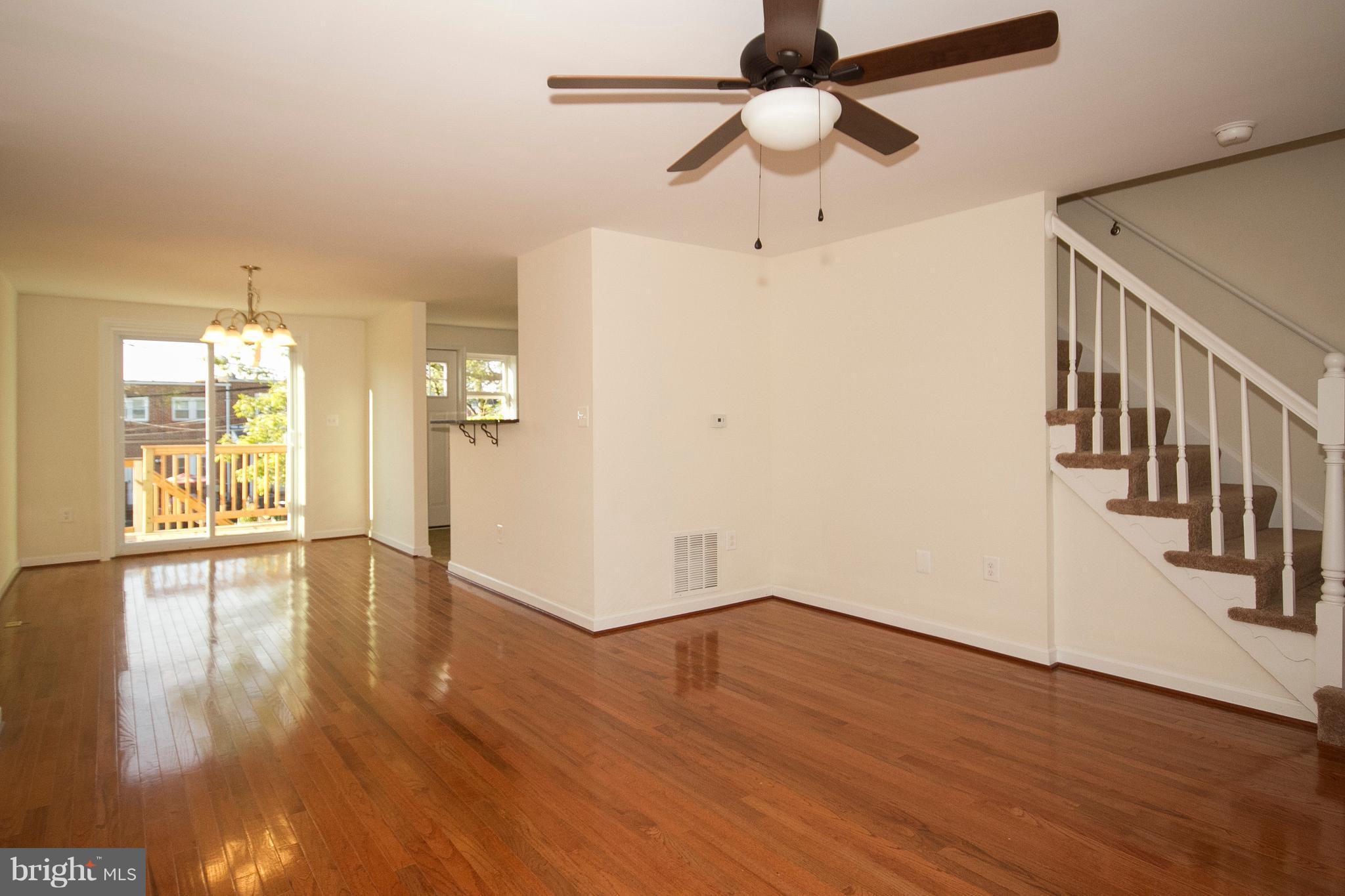 1381 Deanwood Road Baltimore, MD 21234 - Photo 3 of 27 a view of an empty room with wooden floor and a window