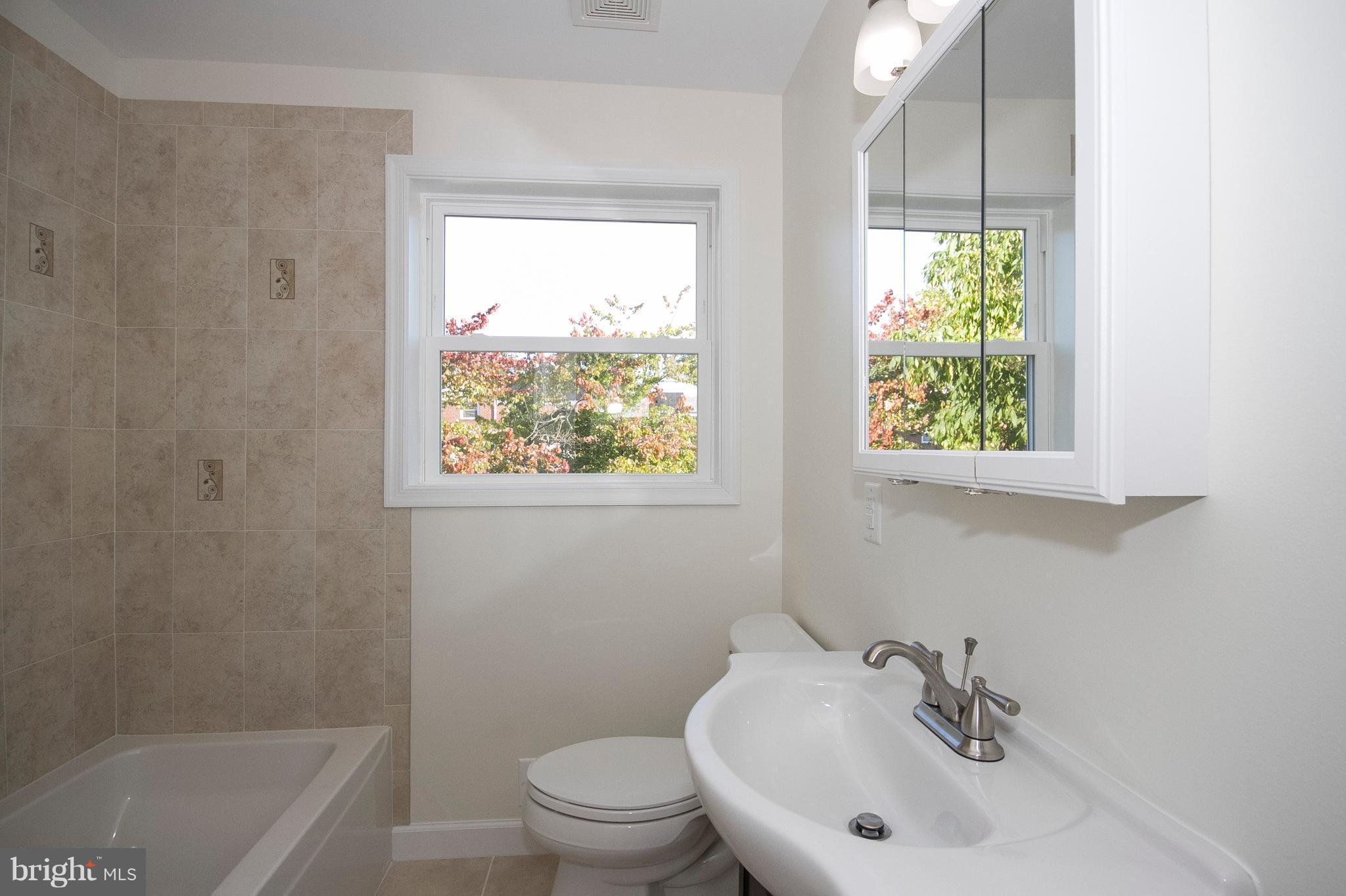 1381 Deanwood Road Baltimore, MD 21234 - Photo 21 of 27 a bathroom with a sink a toilet and a bathtub