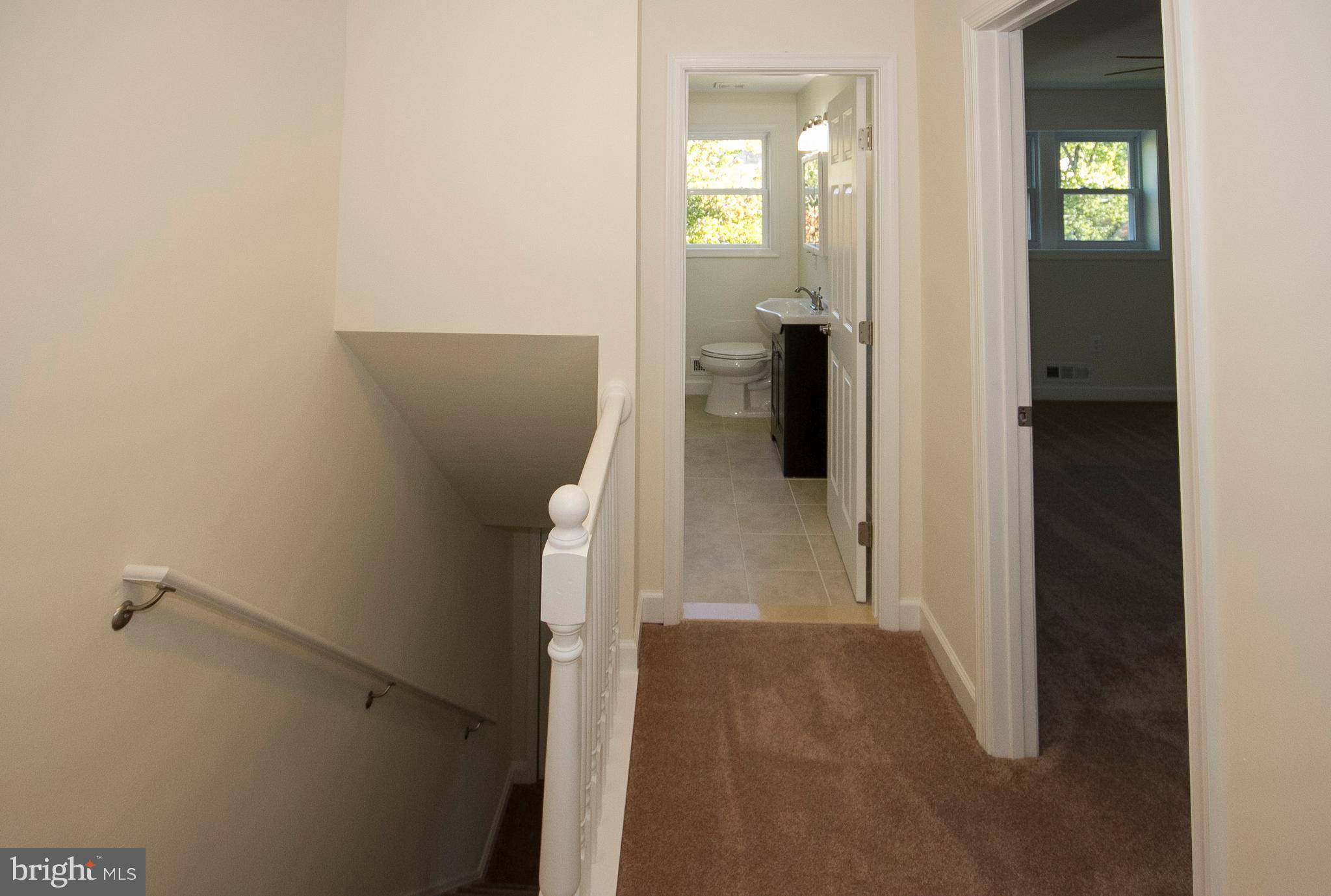 1381 Deanwood Road Baltimore, MD 21234 - Photo 24 of 27 hallway with wooden floor and stairs