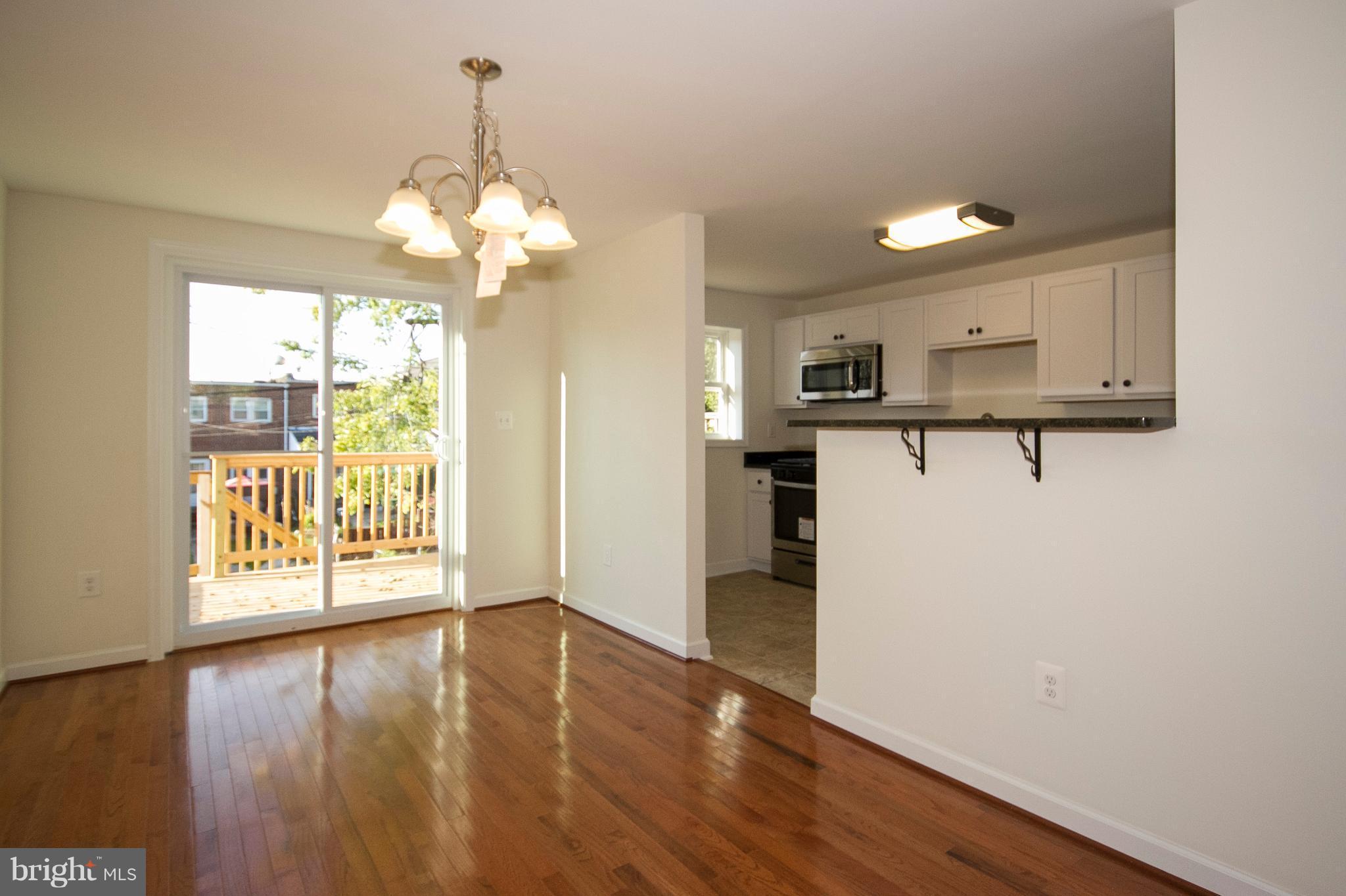 1381 Deanwood Road Baltimore, MD 21234 - Photo 6 of 27 a view of a kitchen with a dishwasher cabinets and wooden floor