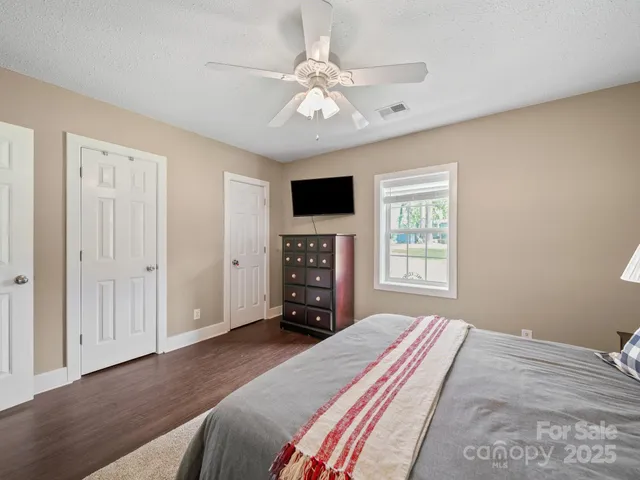 a bedroom with a large bed and a tv