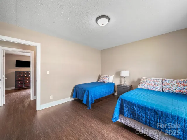 a bedroom with two beds and a chandelier