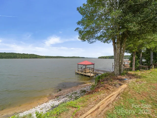 a view of a lake with houses in the back