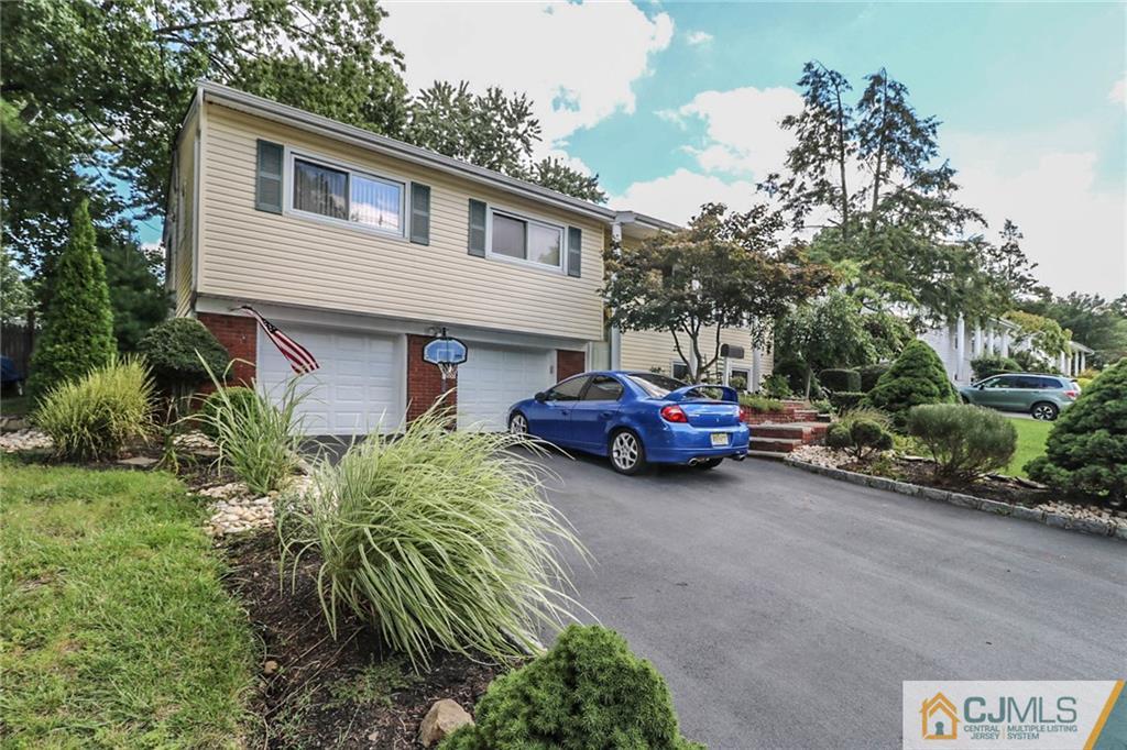 66 Harmon Road Edison, NJ 08837 - Photo 1 of 25 a couple of cars parked in front of a house