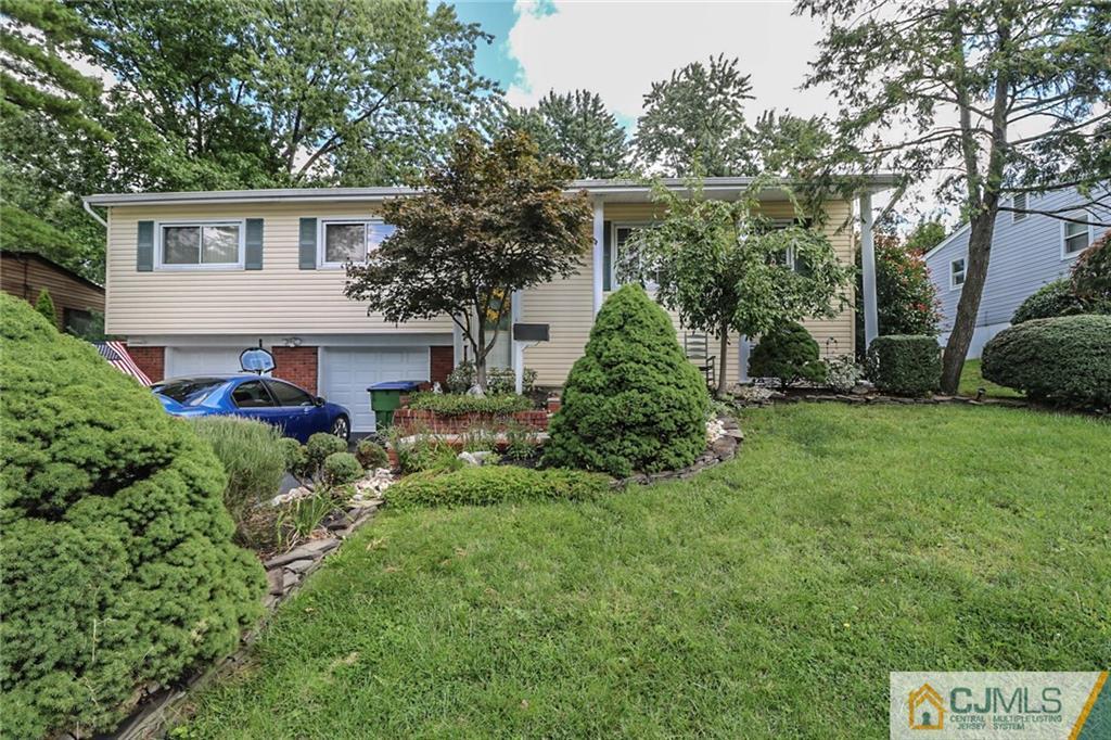 66 Harmon Road Edison, NJ 08837 - Photo 2 of 25 a front view of a house with a yard and potted plants