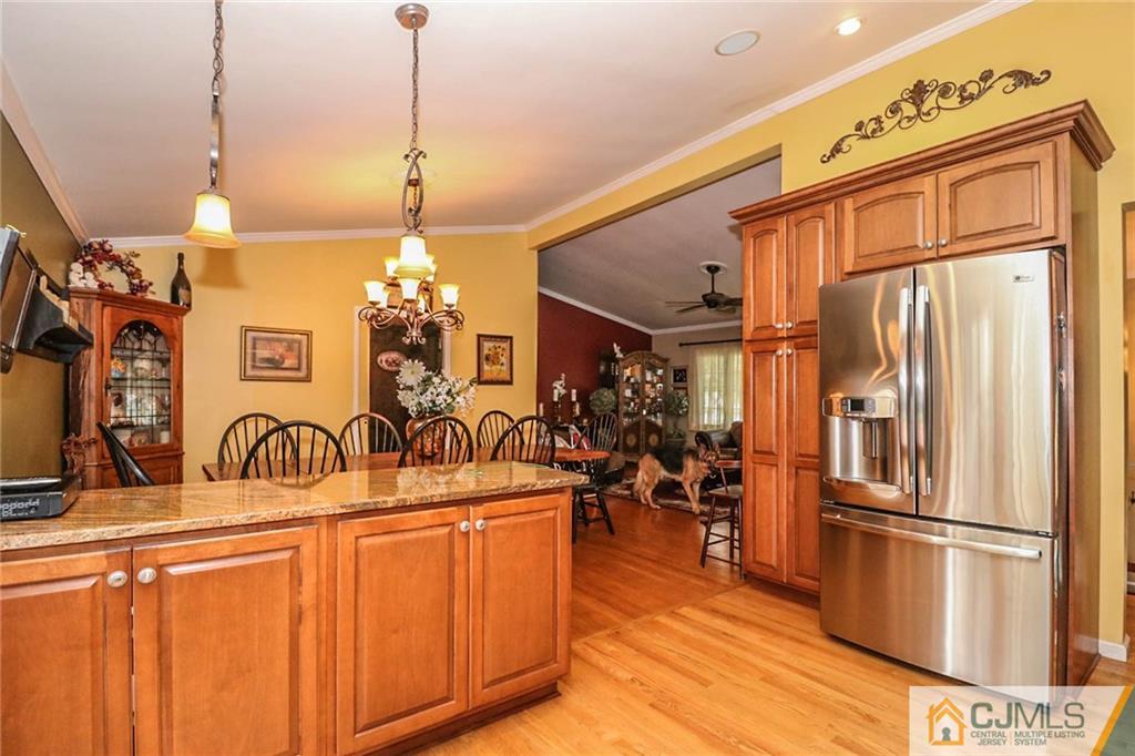 66 Harmon Road Edison, NJ 08837 - Photo 12 of 25 a kitchen with stainless steel appliances a refrigerator a sink dishwasher and white cabinets next to a window