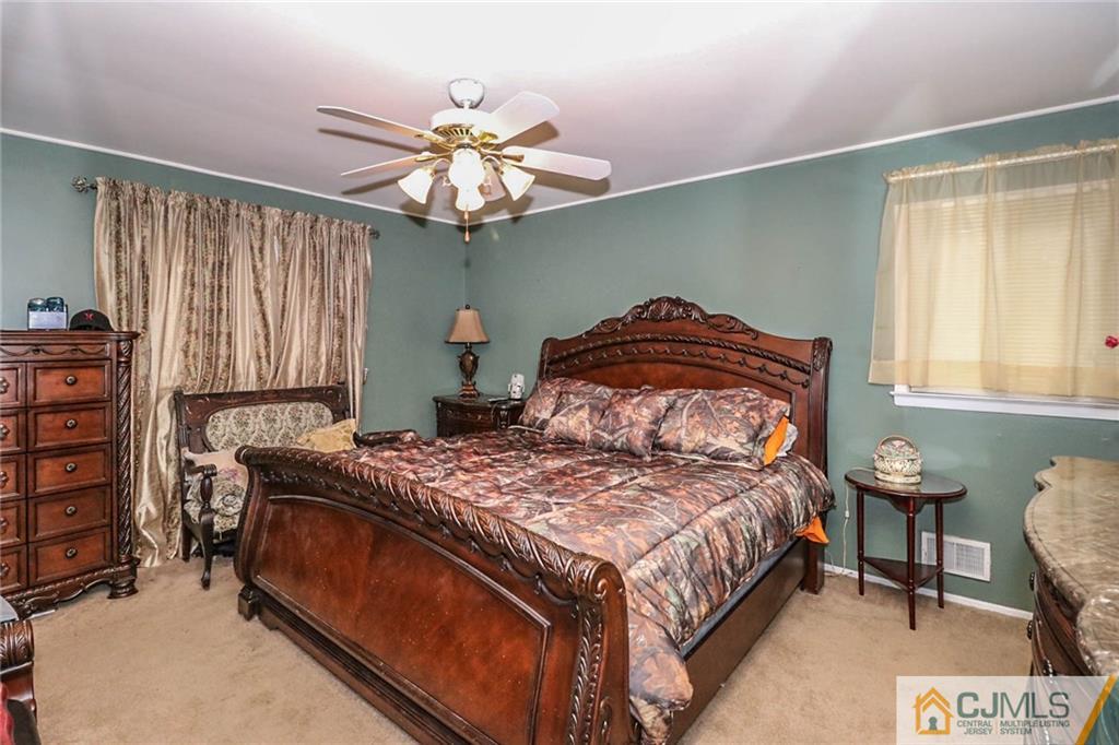 66 Harmon Road Edison, NJ 08837 - Photo 14 of 25 a bedroom with a bed and a chandelier