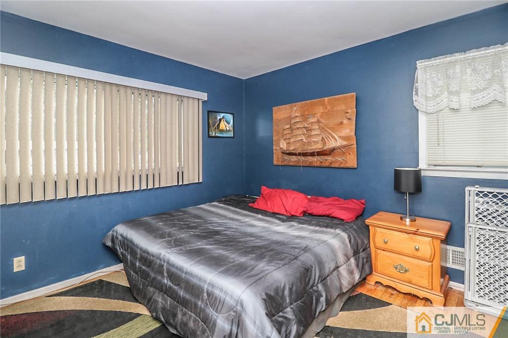 66 Harmon Road Edison, NJ 08837 - Photo 16 of 25 a bedroom with a bed and wooden floor