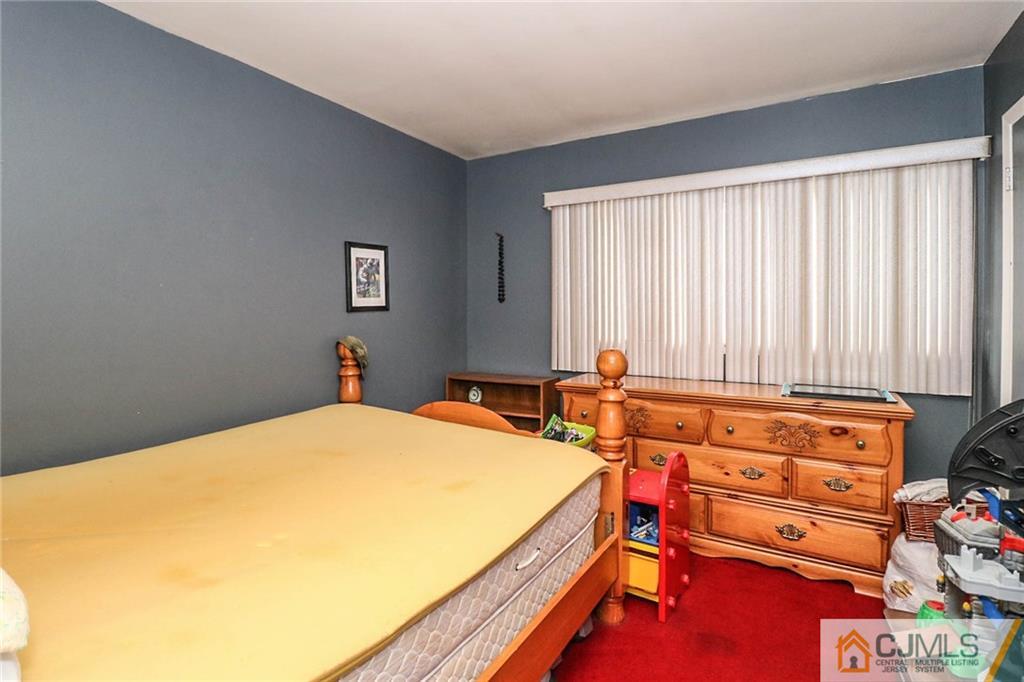 66 Harmon Road Edison, NJ 08837 - Photo 17 of 25 a bedroom with a bed and a dresser in it